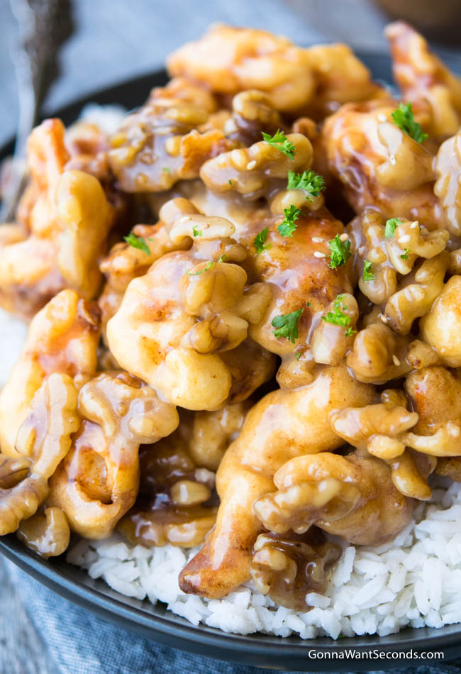 A bowl of rice topped with Honey Walnut Shrimp.