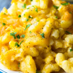 Pioneer Woman mac and cheese on a plate, topped with chopped parsley