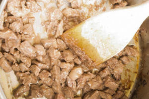 Browning pieces of cubed beef in the pot