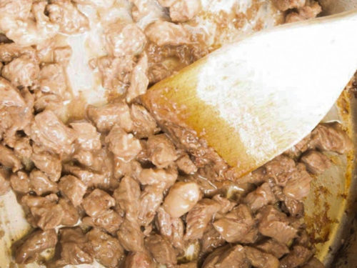 Browning pieces of cubed beef in the pot