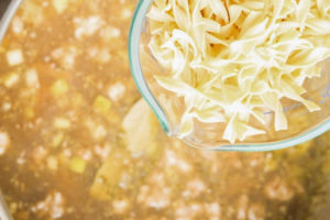 Adding egg noodles in the pot