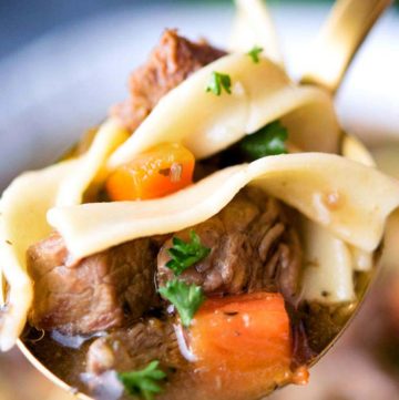 Beef Noodle Soup on a spoon, close up