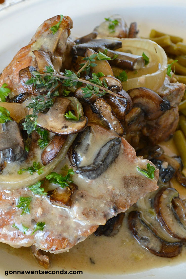 easy slow cooker pork chops topped with mushrooms smothered in gravy