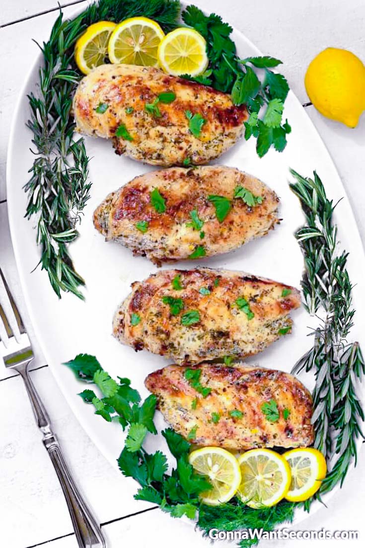 lemon greek chicken garnished with fresh herbs on a plate