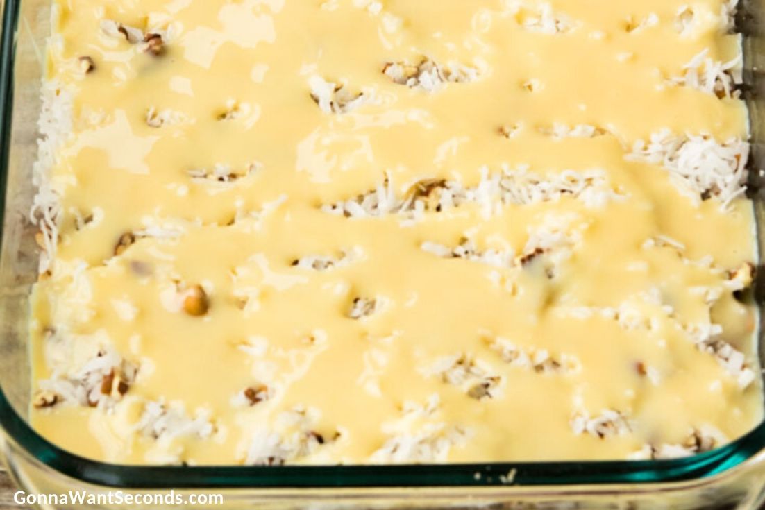 How to make 7 Layer Bars, adding condensed milk to the layer