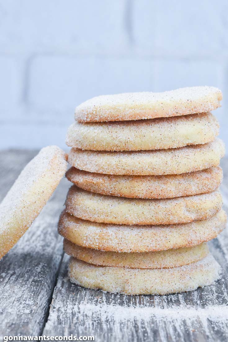 Biscochitos stack on top of each other, on a wooden table