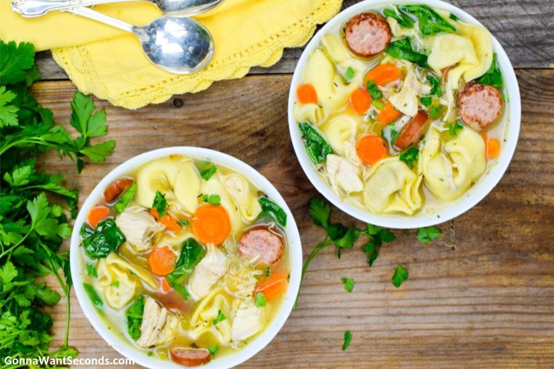 Chicken Tortellini Soup in a white bowl, top shot