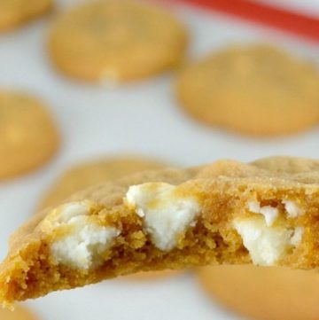 Pumpkin Spice Cookies cut in half, showing white chocolate chips inside