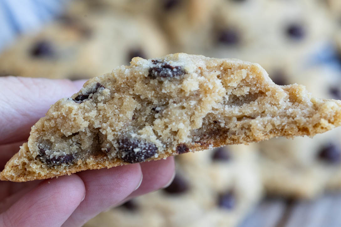 These Best Chocolate Chip Cookies are thick, chewy, buttery, and loaded with melty chocolate for the ultimate bakery-style cookie. #bestchocolatechipcookies #chocolatechipcookies the best chocolate chip cookies cut in half, close up