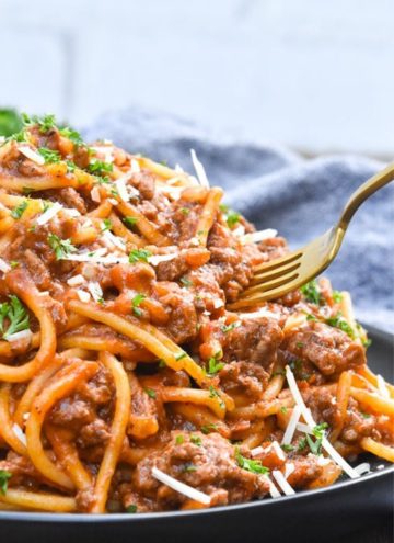 Fork picking Instant Pot Spaghetti on a plate