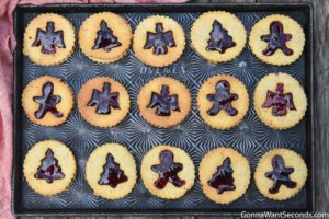 Linzer cookies arranged on a baking sheet