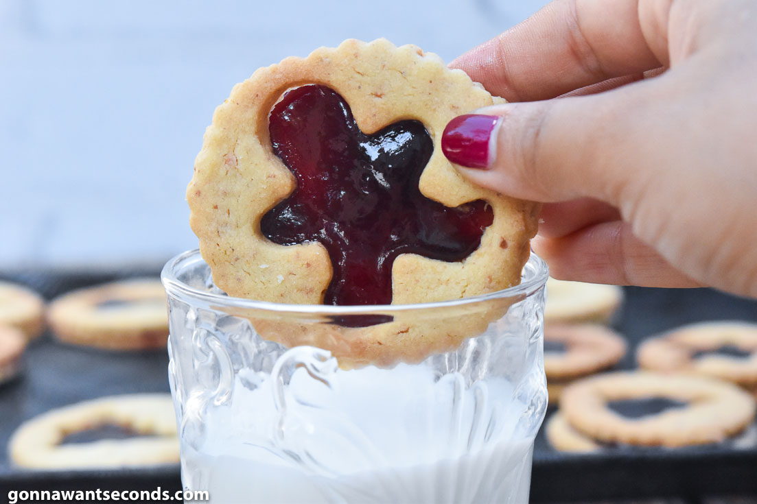 Dunking Linzer cookies in a glass of milk