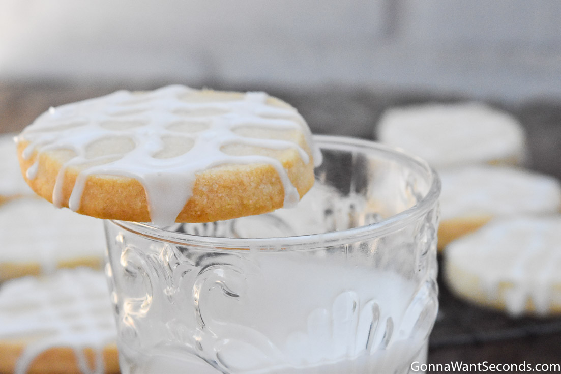 almond shortbread cookies placed on top of a glass of milk