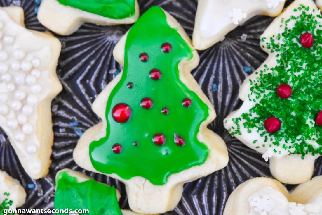 Christmas sugar cookies on a baking sheet with icings and decoration