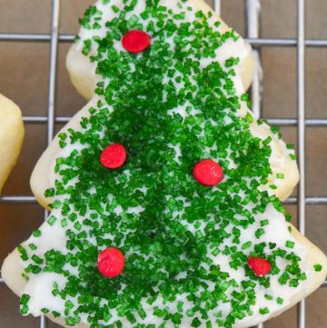 Christmas sugar cookies on a cooling rack with icings and decoration