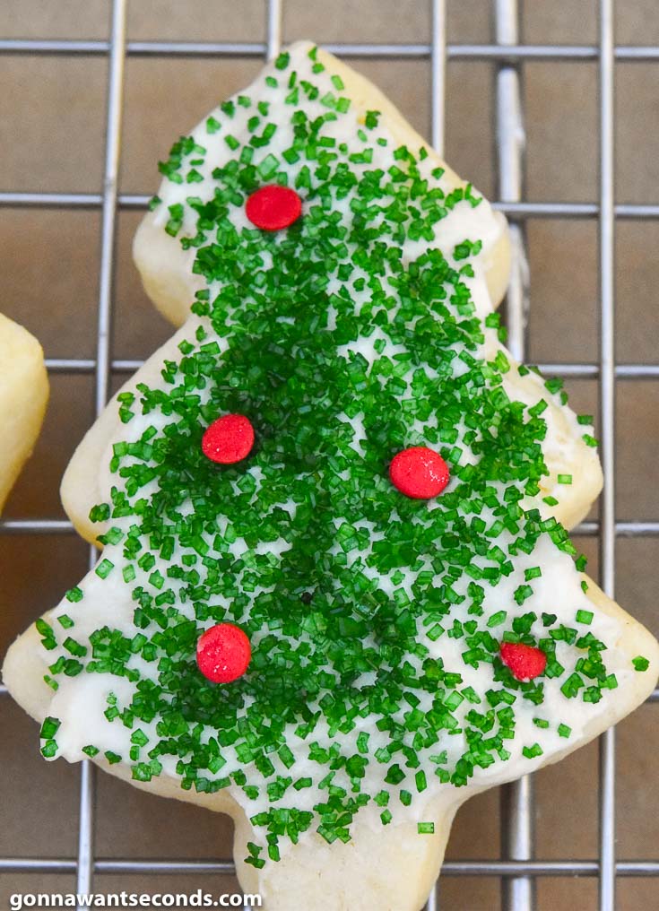 Christmas sugar cookies on a cooling rack with icings and decoration