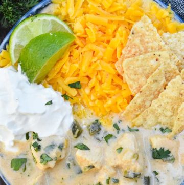 Creamy chicken tortilla soup with toppings, in a bowl