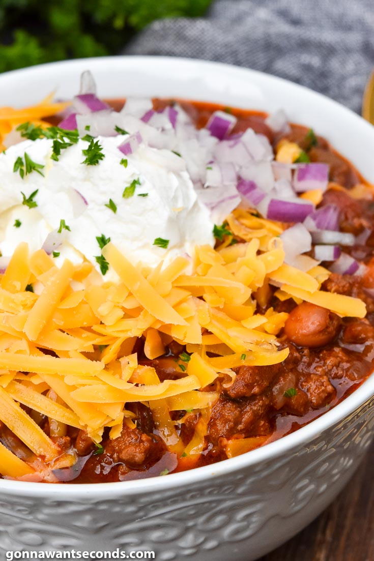 instant pot chili with toppings, in a white bowl