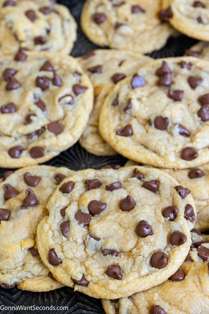 This easy chocolate chip cookies recipe checks all the boxes of a great cookie! They’re moist, chewy, chocolaty, & super easy to make! Prep in 15 minutes! #chocolatechipcookies #chipcookies easy chocolate chip cookies on a baking pan