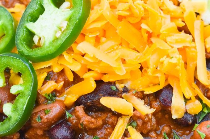 Pioneer Woman Chili topped with cheese, jalapeno, and lime, on a bowl