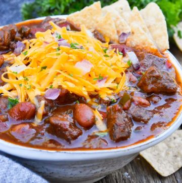 Steak Chili with toppings, on a white bowl