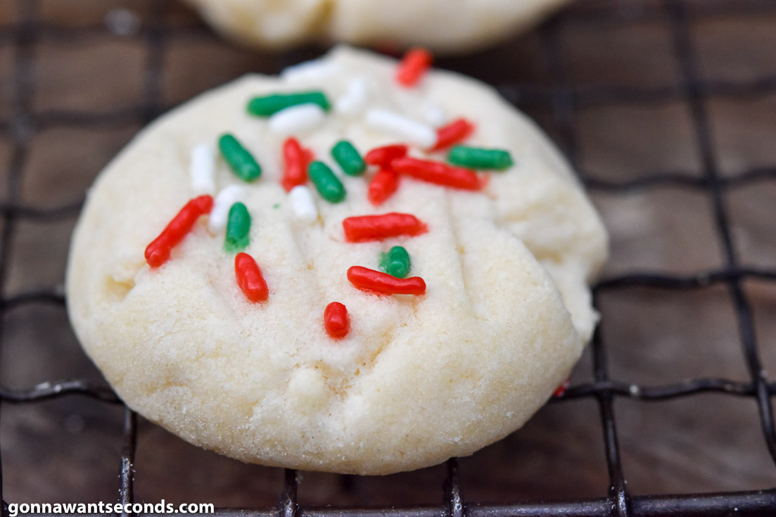 Whipped shortbread cookies on a cooling rack