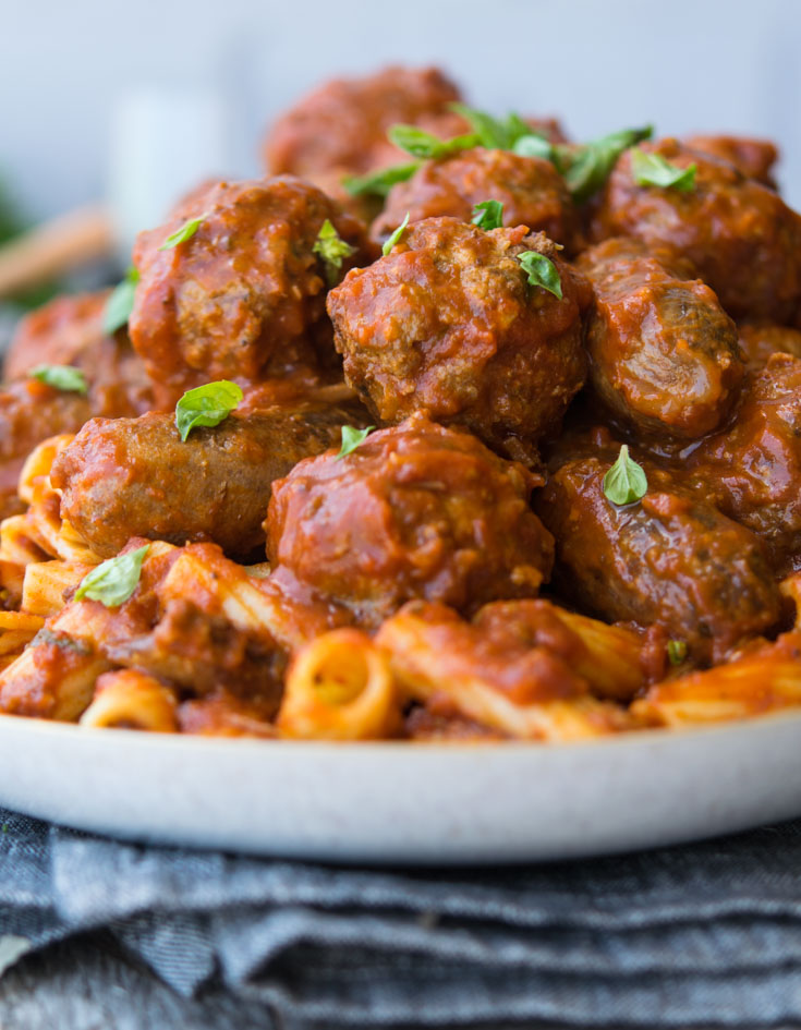 A plateful of pasta topped with Italian Sunday Gravy and meatballs