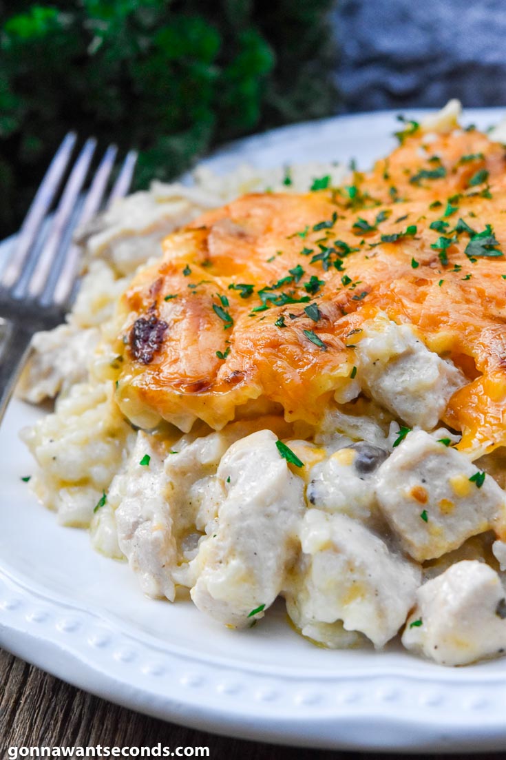 Chicken and rice casserole topped with melted cheese, on a plate
