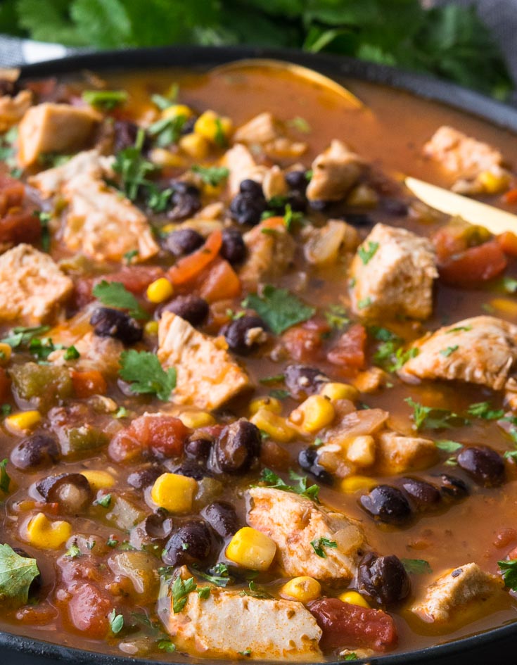 one pot mexican chicken soup in a bowl with spoon