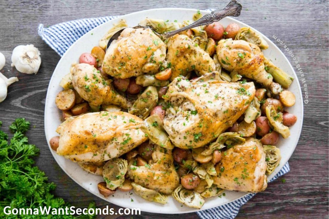 Chicken Vesuvio on a serving plate with serving spoon