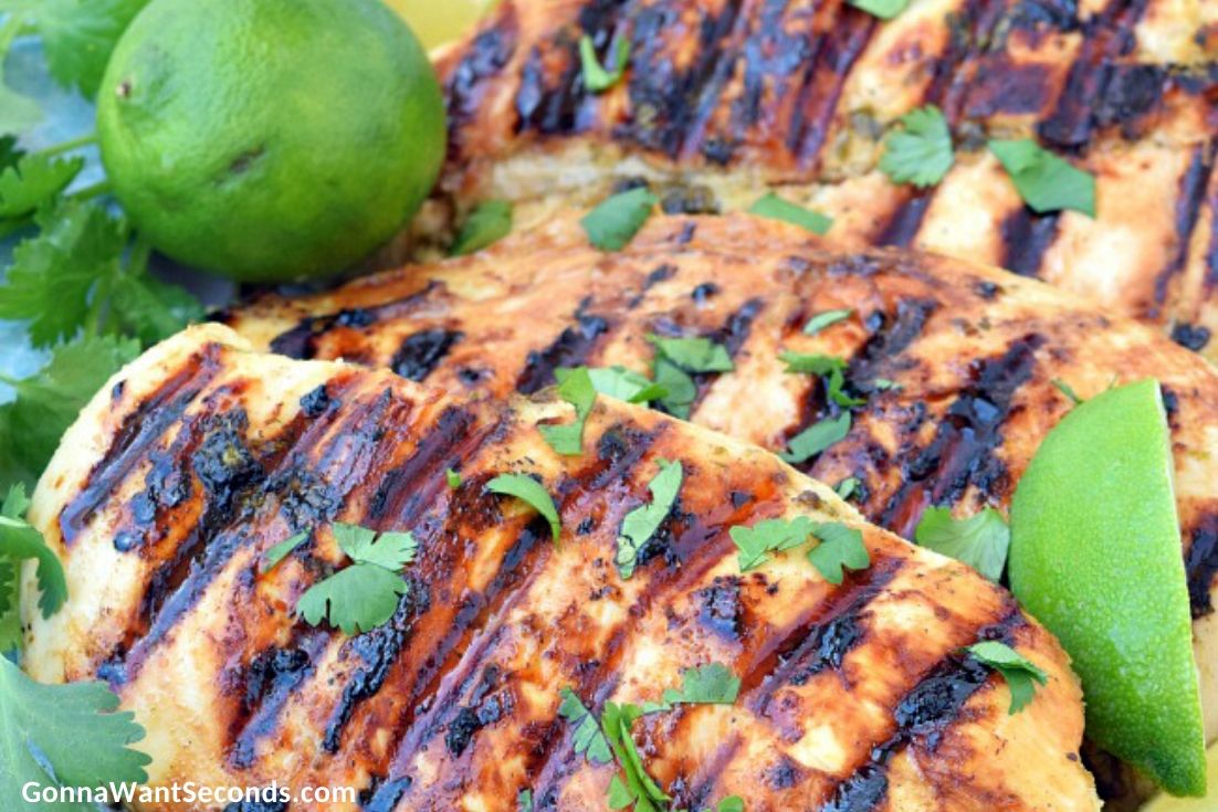 Cilantro lime chicken garnished with lime wedges and cilantro on a plate