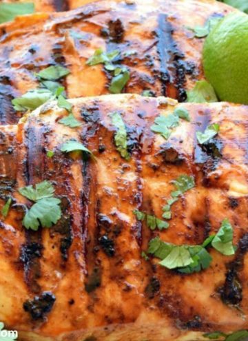 cilantro lime chicken garnished with lime wedges and cilantro on a plate