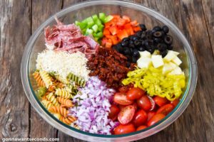 How to make Pasta Salad with Italian Dressing, adding remaining ingredients to the pasta mixture