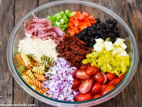 How to make Pasta Salad with Italian Dressing, adding remaining ingredients to the pasta mixture