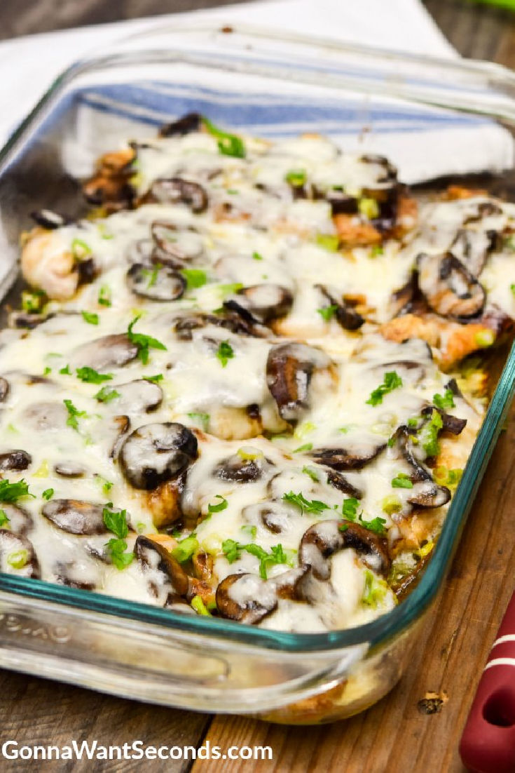 Chicken Lombardy topped with mushroom and cheese in a casserole dish