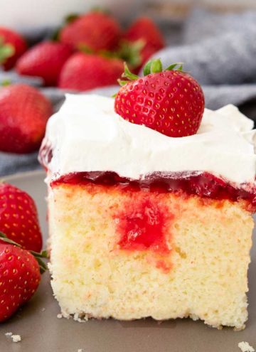 A slice of Strawberry Poke Cake on a plate
