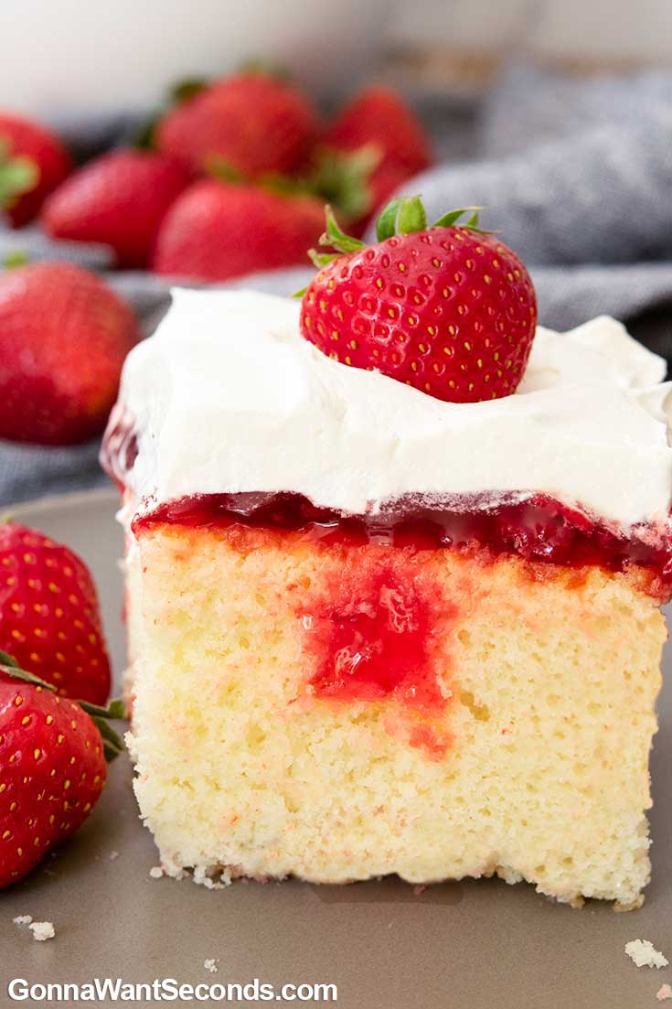 A slice of Strawberry Poke Cake on a plate