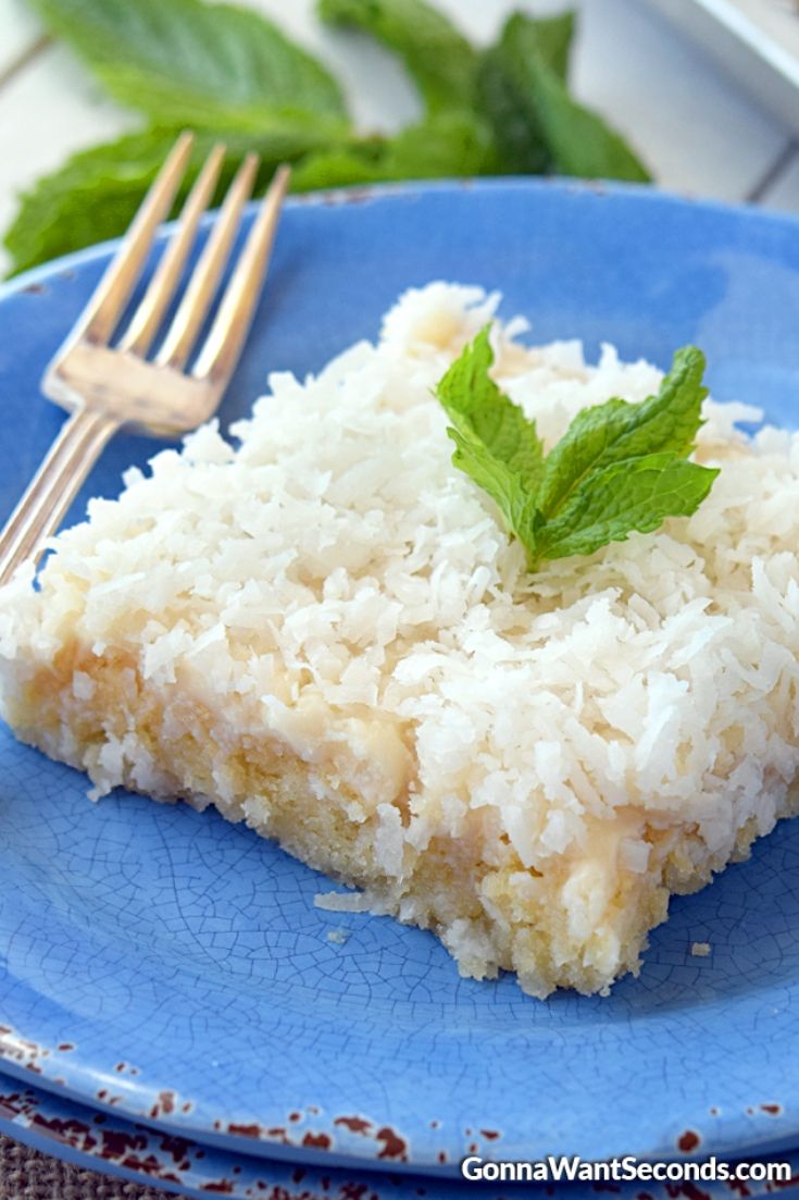A slice of Coconut Sheet Cake on a plate