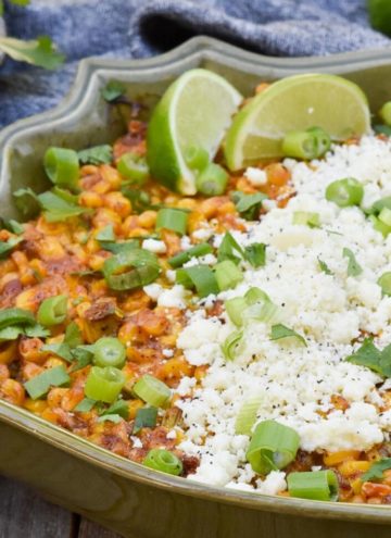 Mexican street corn casserole topped with cheese and lime