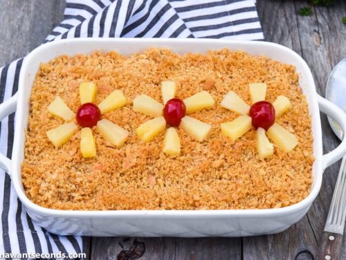 Baked Pineapple Casserole topped with pineapple tidbits and cherries