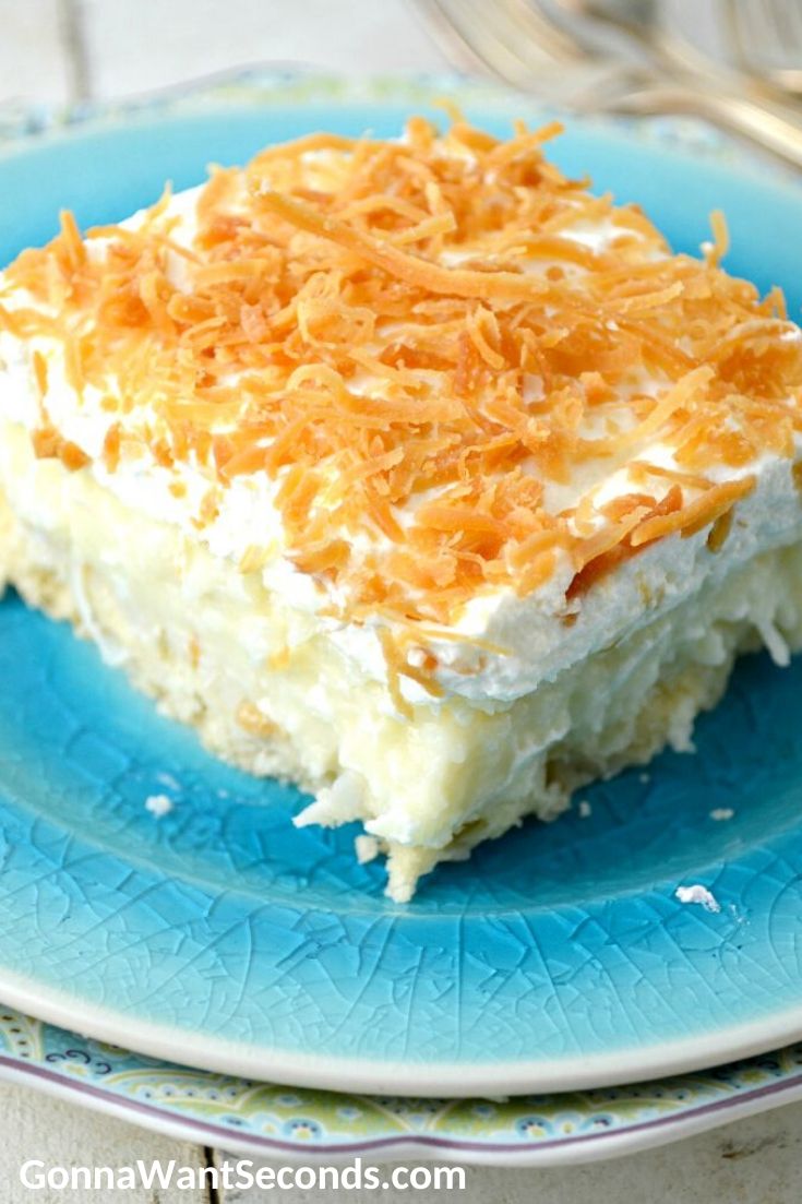 A slice of Coconut Cream Pie Bars on a blue plate