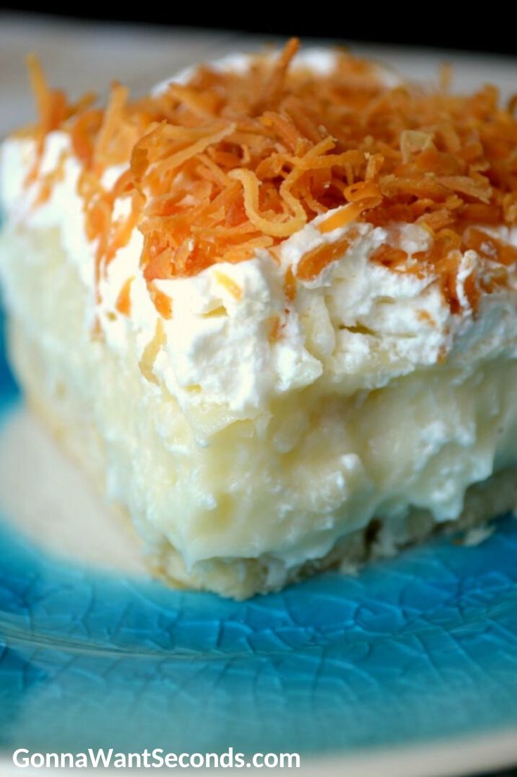A slice of Coconut Cream Pie Bars on a blue plate