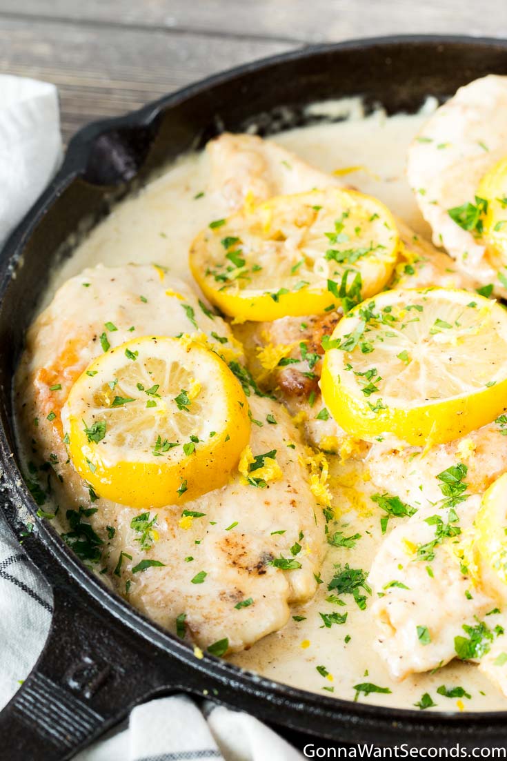 Creamy Lemon Chicken with sauce in a cast iron skillet