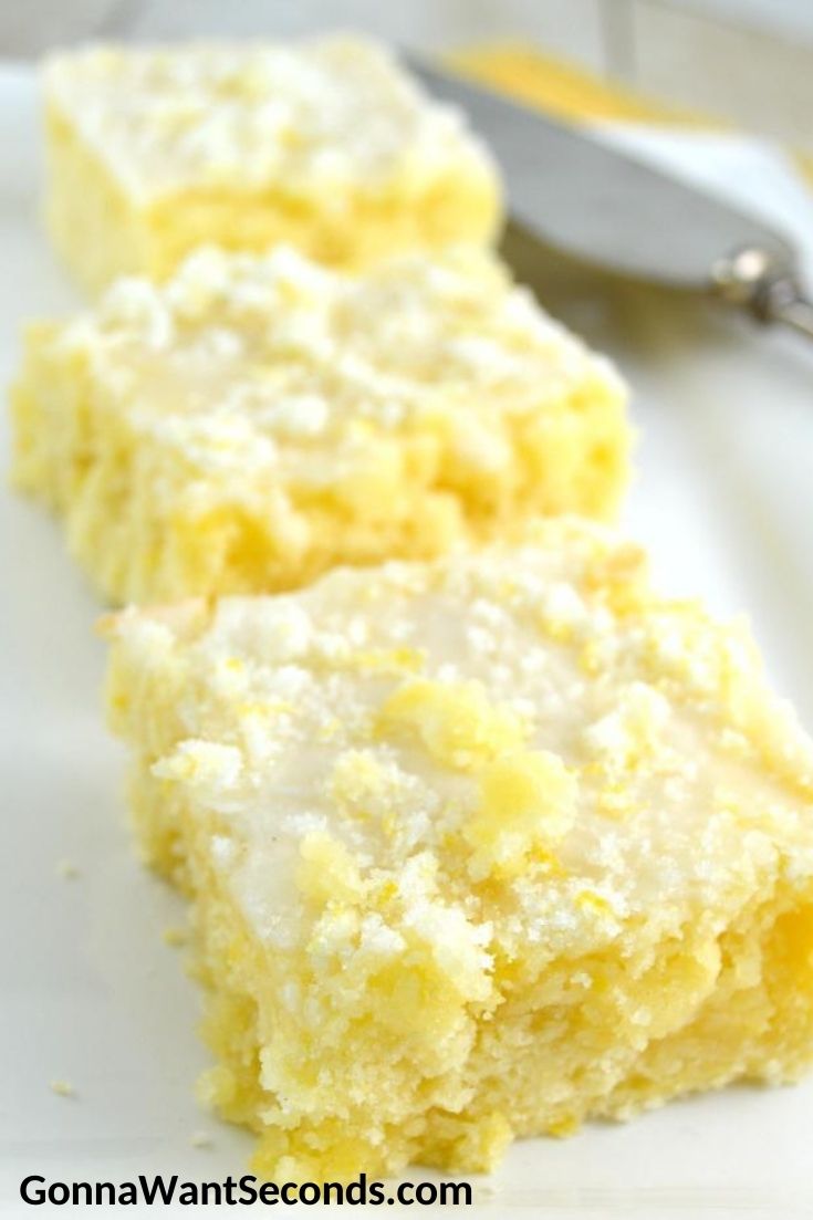 A slice of lemon buttermilk cake with lemon glaze on a plate