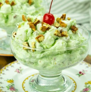 Watergate salad with cherry on top in a sherbet glass