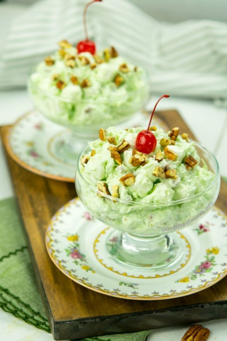 Watergate salad with cherry on top in a sherbet glass