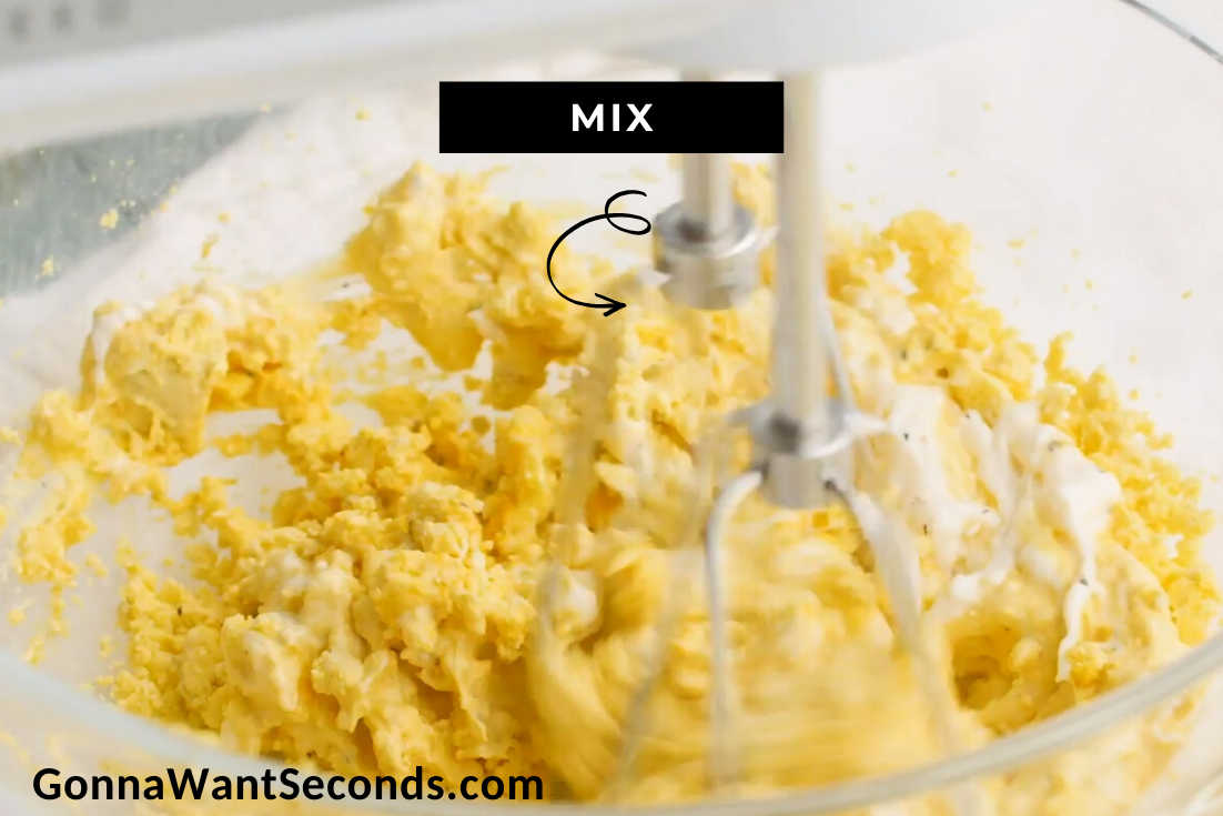 How to make classic deviled eggs, mixing egg yolk with other ingredients