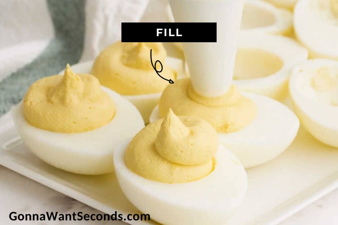 How to make classic deviled eggs, piping egg mixture on egg whites
