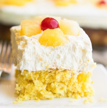 A slice of pineapple sunshine cake on a plate