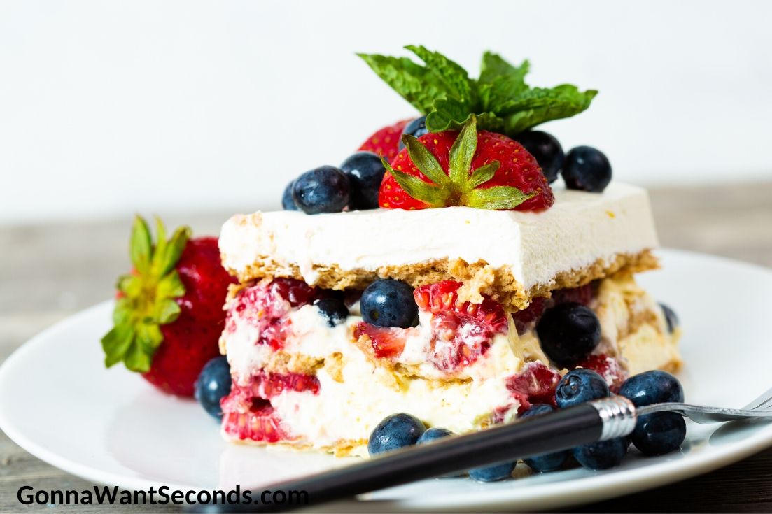 Summer berry icebox cake topped with berries, on a plate